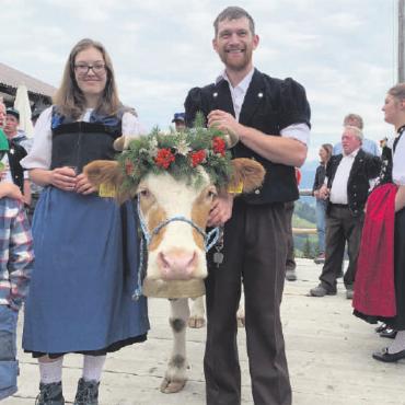 Ein unvergessliches Fest auf der Alp Plani - Sidonia Romang und Sedric Hefti mit der schön geschmückten Meisterkuh Amsel, welche die Aufmerksamkeit sichtlich genoss. FOTO: ZVG