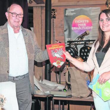 Lions Club Simmental gegründet - Hans Moratti und Vanessa Wyss tauschen die Wimpel ihrer Clubs aus.