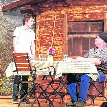 Uraufführung «Für d’Bärge gebore» - Erster Akt: Barbara, die Wirtin des Bergrestaurants, im angeregten Gespräch mit Roland, Vater des verschollenen Walters.