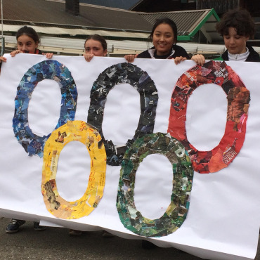 Olympisches JFK-Gold geht an das Team Kilimanjaro - Die Fahnenträger der Schlussfeier.