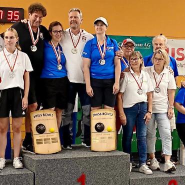 Gold und Silber für die Herren des Bowls Club Gstaad - Foto oben: Spielszene Damen Vorrunde. Foto unten: Bowls-Pairs-Schweizermeisterschaften 2024, Podest Damen und Herren. FOTOS: ZVG